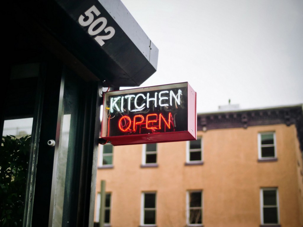 Learn about the benefits of incorporating in Canada, a sign that reads Kitchen Open