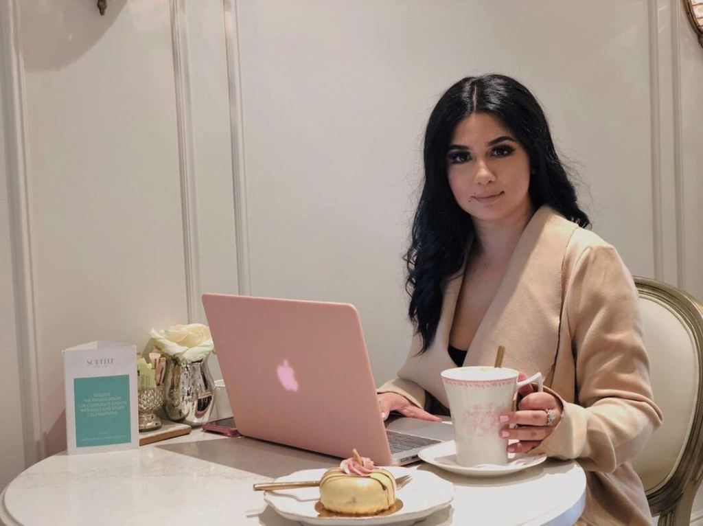 Photo of Negar Jafari, Life and Business Coach at Innervibration, working on a laptop.