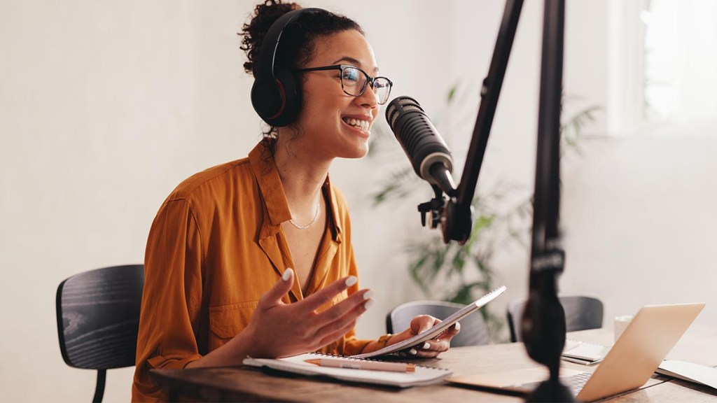 A woman records a podcast to generate passive income