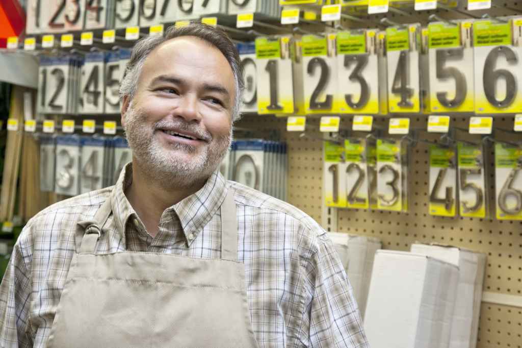 A man stands in a hardware store after acquiring a NEQ in quebec